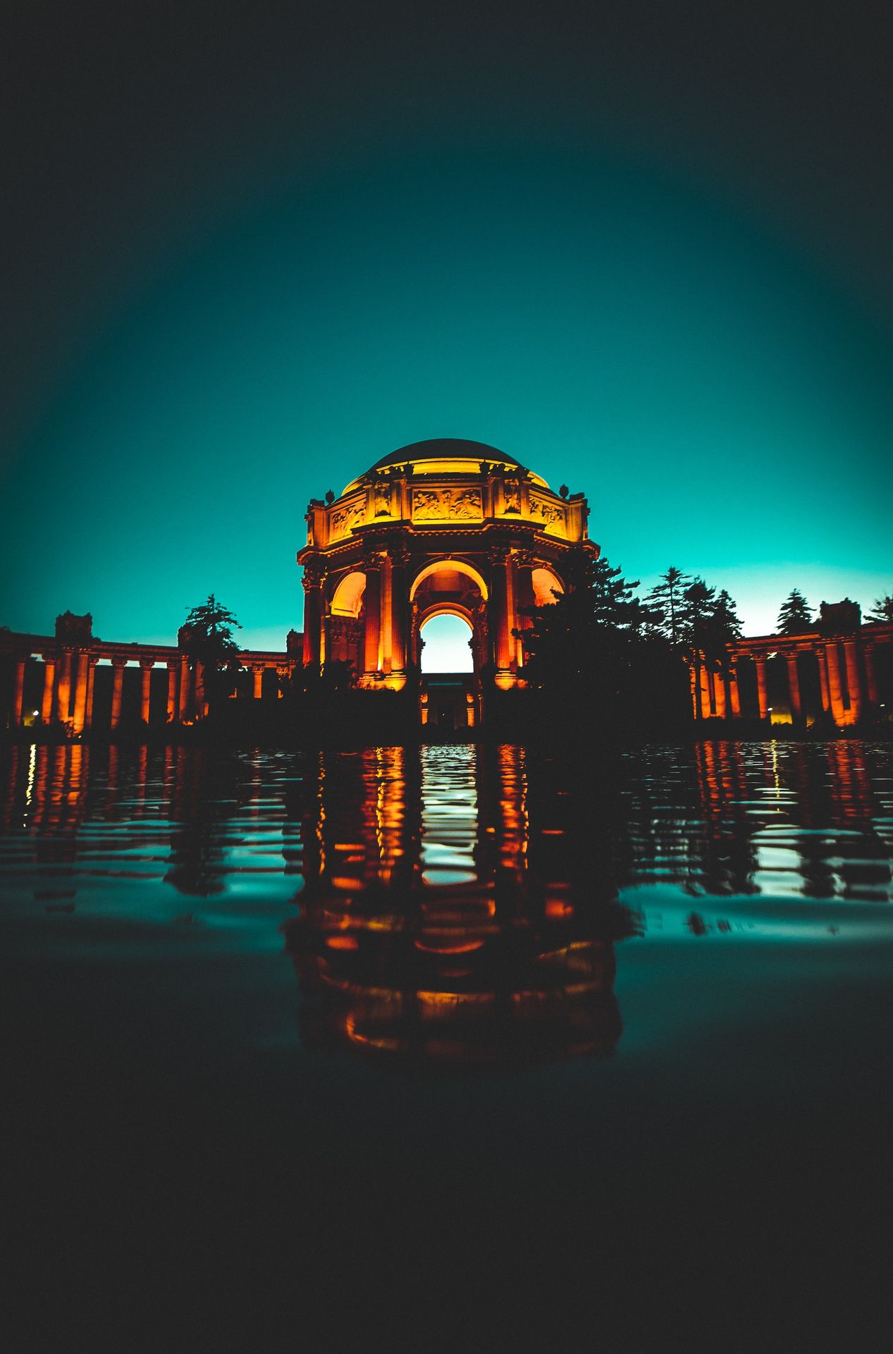 lighted concrete dome building near body of water